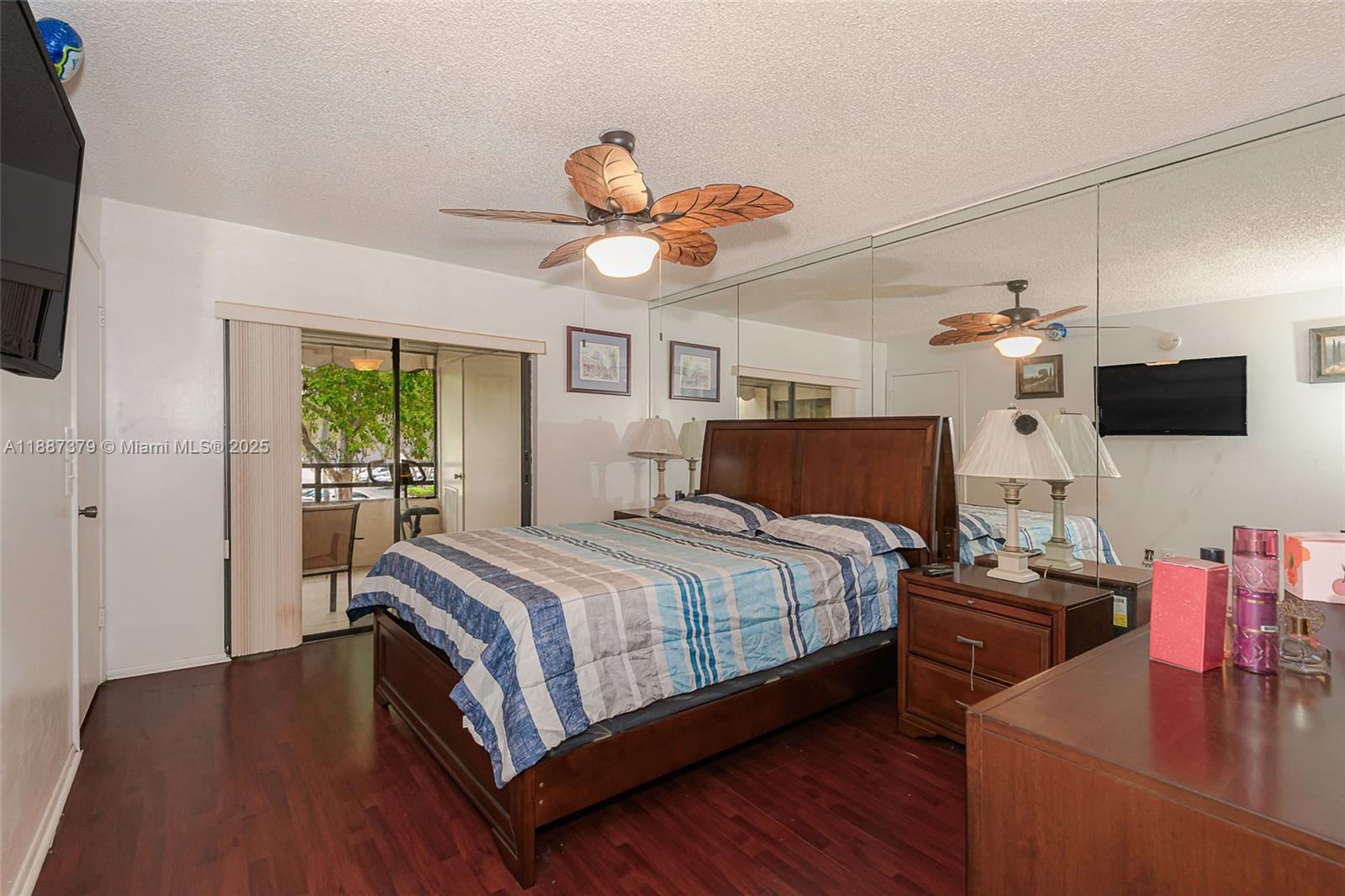 20015 Northeast 3rd Court, Unit 6 Miami, FL 33179 - Photo 22 of 31 a bedroom with a bed and a flat screen tv