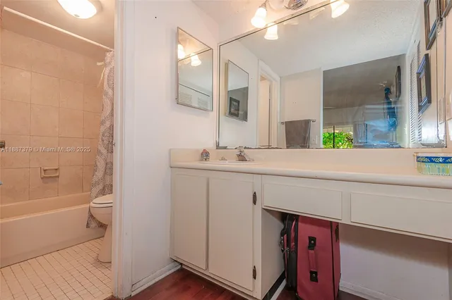 a bathroom with a bathtub a sink and a mirror