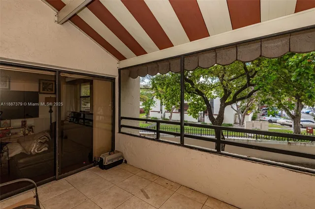 a vase of flowers sitting on a floor