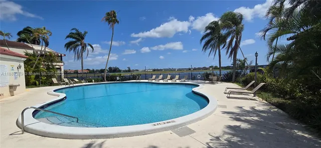a view of a swimming pool with a lounge chairs