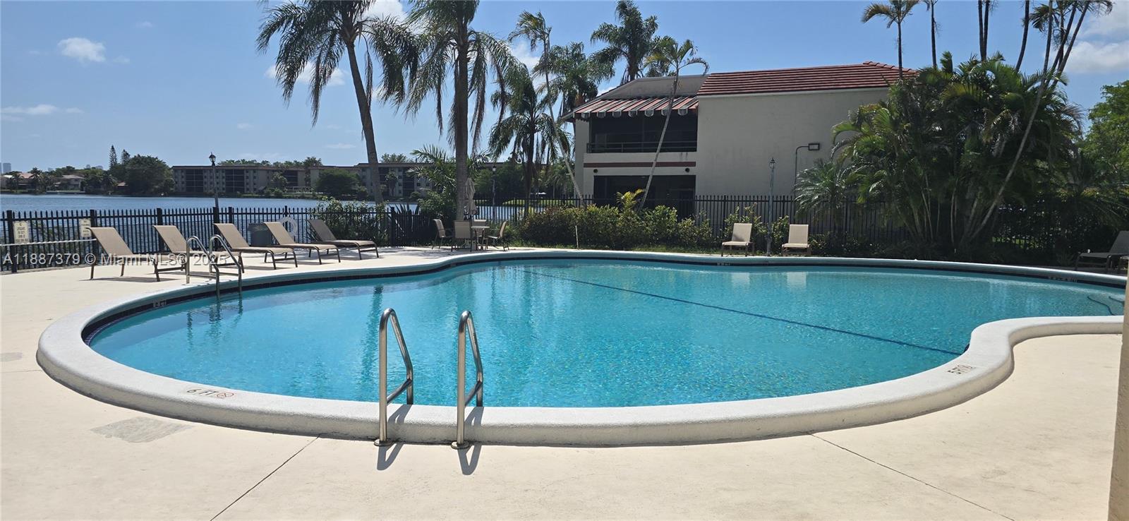 20015 Northeast 3rd Court, Unit 6 Miami, FL 33179 - Photo 29 of 31 a view of a swimming pool with a lounge chairs