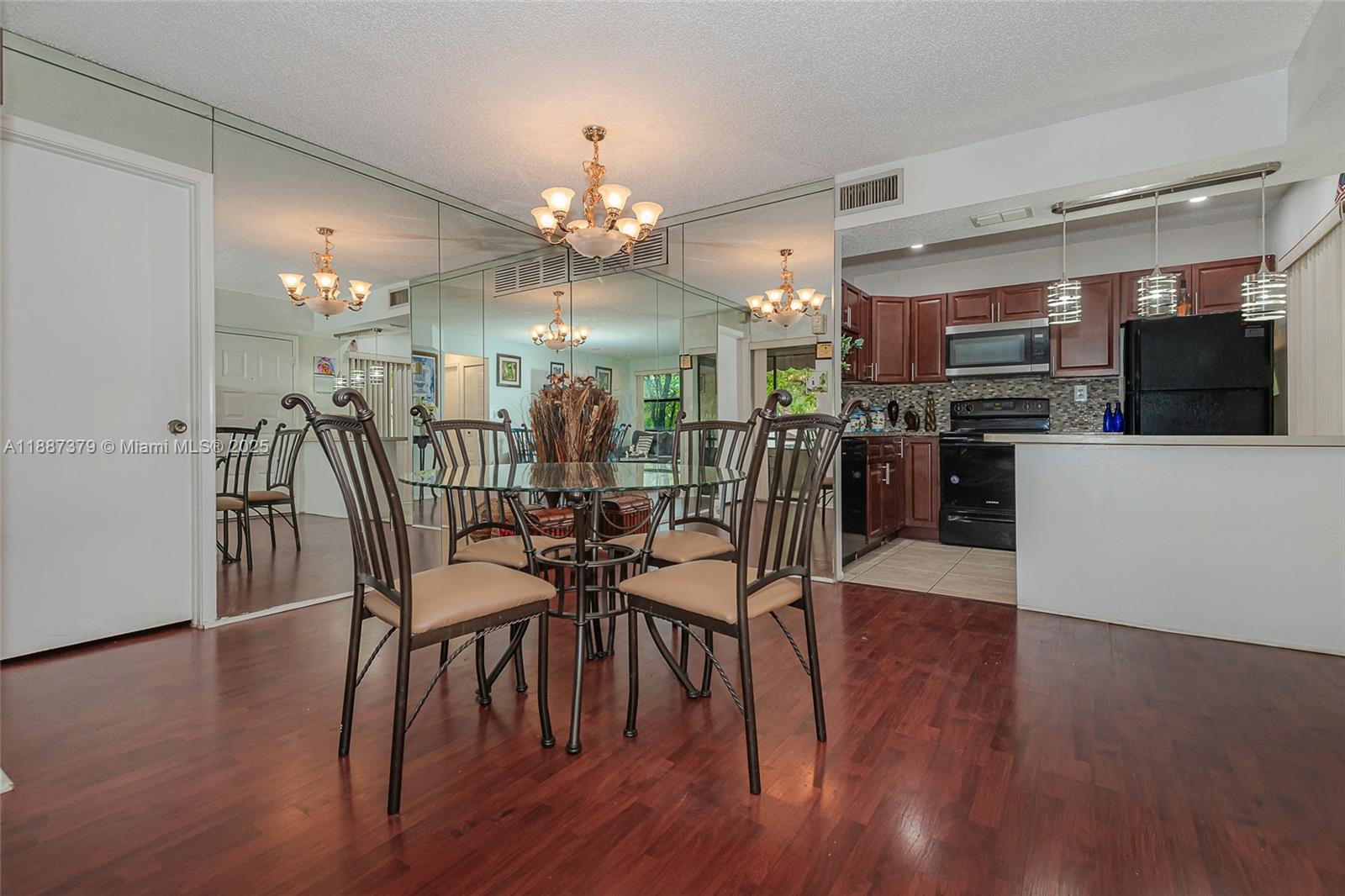 20015 Northeast 3rd Court, Unit 6 Miami, FL 33179 - Photo 3 of 31 a view of a dining room with furniture and wooden floor