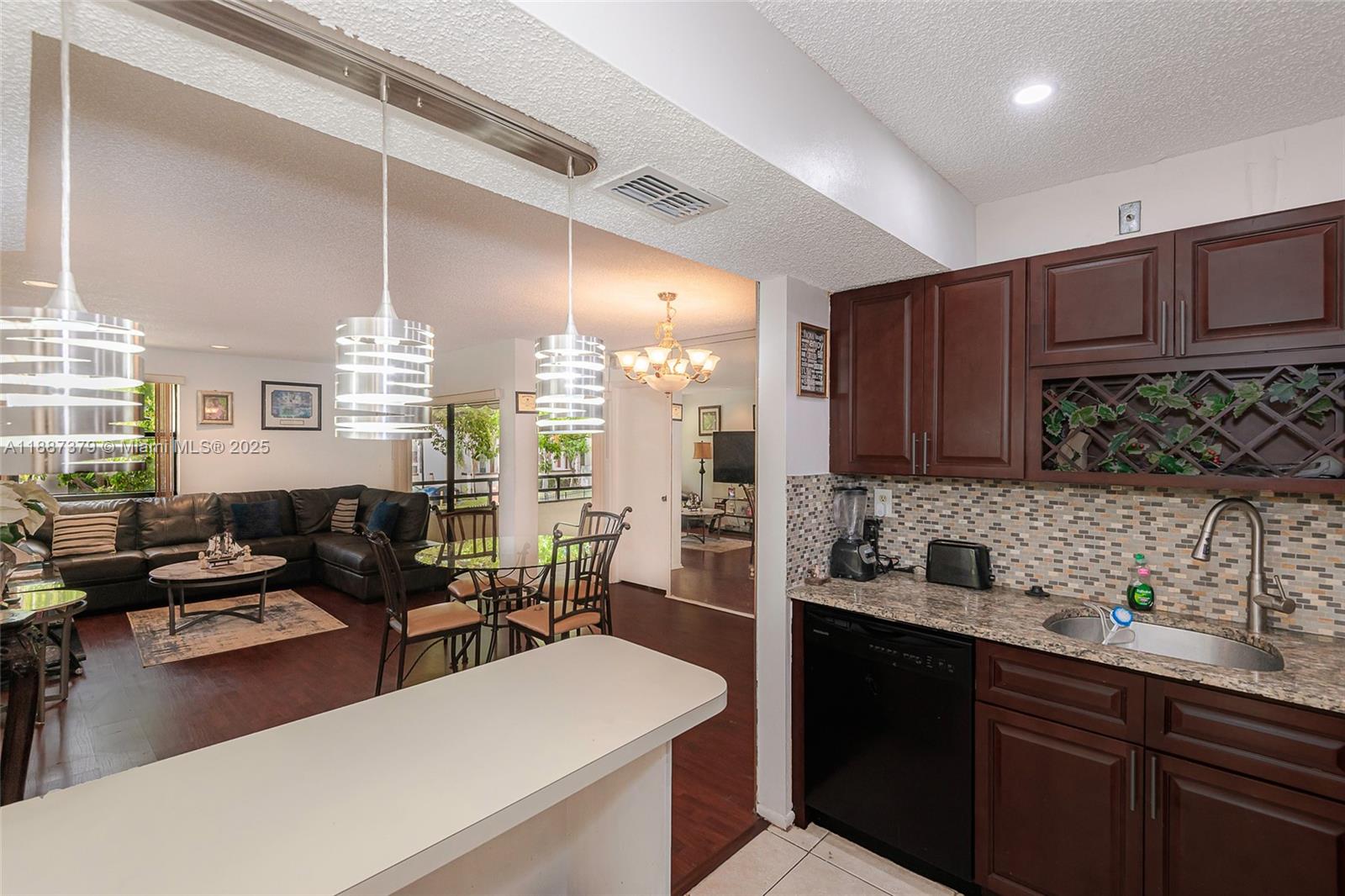 20015 Northeast 3rd Court, Unit 6 Miami, FL 33179 - Photo 6 of 31 a kitchen with sink refrigerator and cabinets