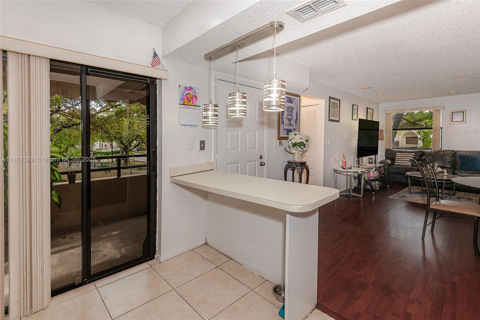 20015 Northeast 3rd Court, Unit 6 Miami, FL 33179 - Photo 9 of 31 a view of a livingroom with furniture wooden floor a chandelier