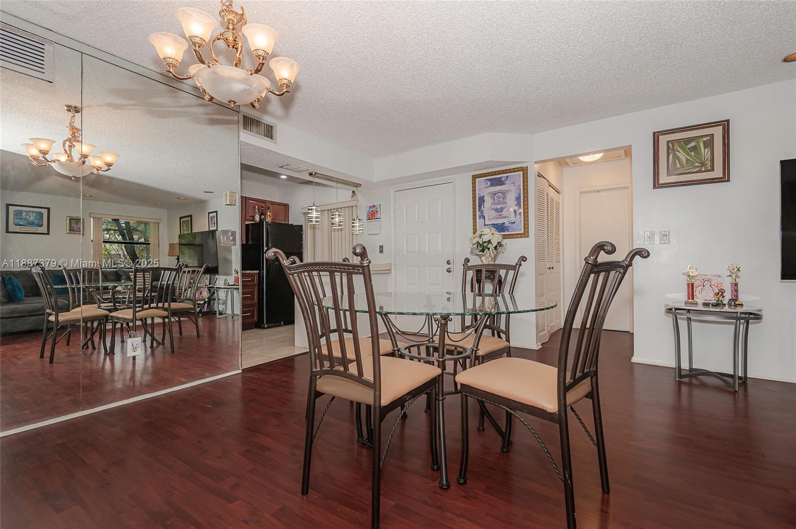 20015 Northeast 3rd Court, Unit 6 Miami, FL 33179 - Photo 10 of 31 a view of a dining room with furniture and wooden floor