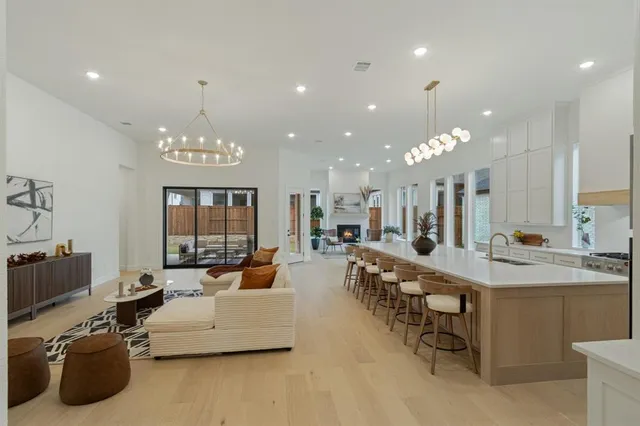 a large living room with furniture a chandelier and a chandelier