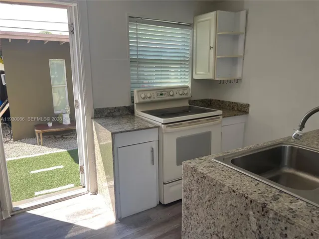 a kitchen with a sink stove and cabinets