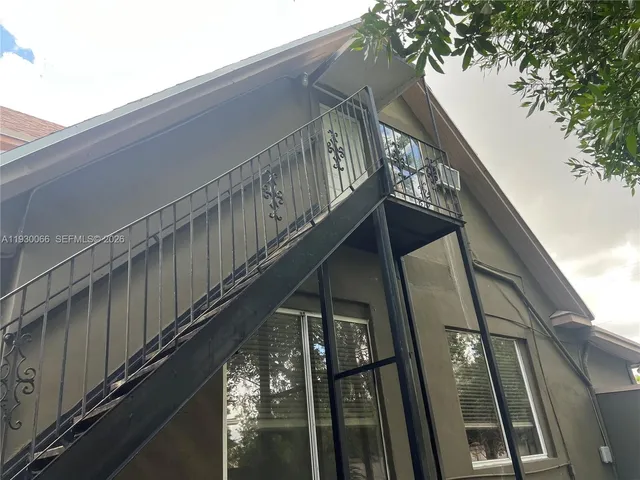 a view of a porch with a bench and plants