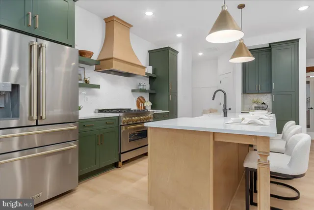a kitchen with a sink stainless steel appliances and cabinets