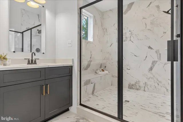 a bathroom with a shower sink and mirror