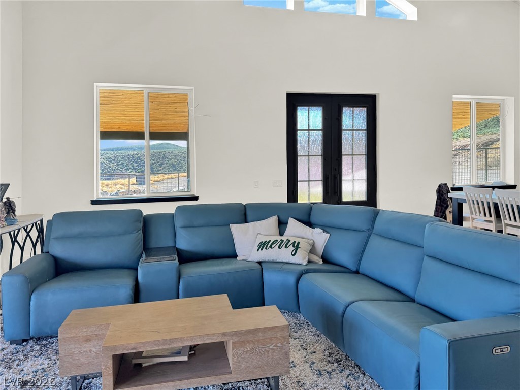 9393 North 93rd Highway Caliente, NV 89008 - Photo 23 of 41 A spacious living area with soaring ceilings and abundant natural light offers scenic outdoor vistas.