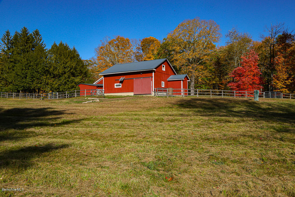 82 Chestnut Hill Loop Montague, MA 01351 - Photo 23 of 36 a front view of a house with a yard and garage