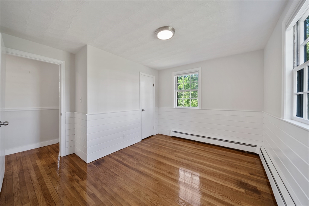 13 Rattlesnake Hill Road Andover, MA 01810 - Photo 13 of 25 an empty room with wooden floor and windows