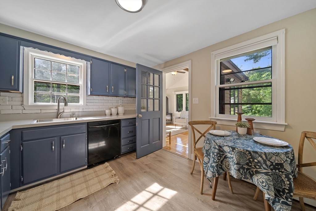13 Rattlesnake Hill Road Andover, MA 01810 - Photo 15 of 25 a kitchen with granite countertop a stove a sink a dining table and chairs
