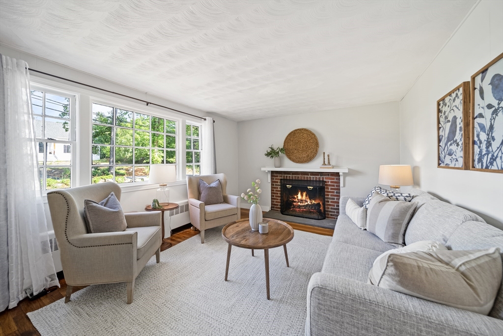 13 Rattlesnake Hill Road Andover, MA 01810 - Photo 6 of 25 a living room with furniture a fireplace and a large window