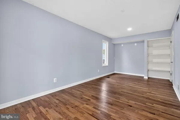 a view of an empty room and wooden floor