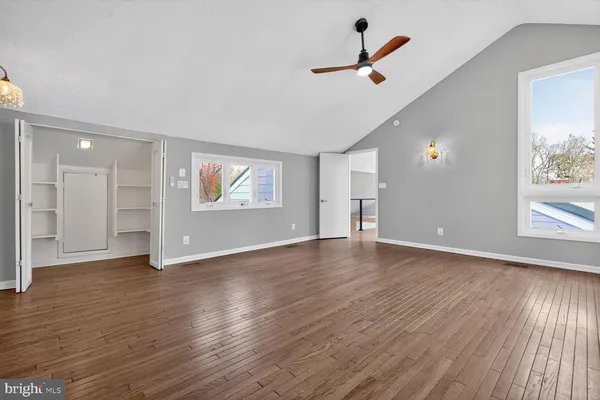 a view of empty room with wooden floor