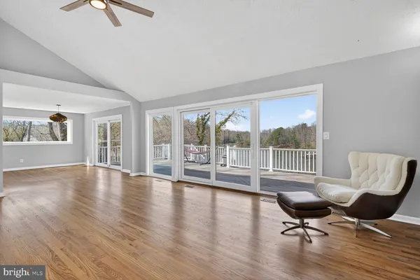 a living room with a rug chairs and a table