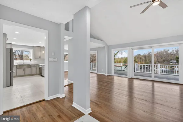 a large kitchen with cabinets wooden floor and stainless steel appliances