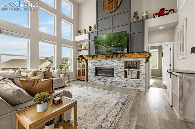 a living room with furniture a flat screen tv and a fireplace