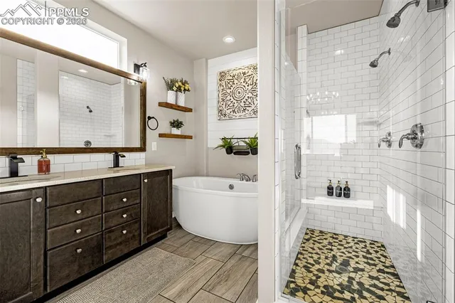 a bathroom with a bathtub shower sink vanity and toilet