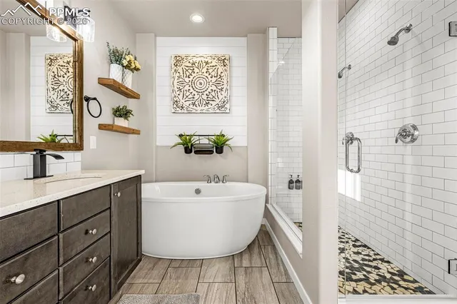 a bathroom with a tub sink and mirror