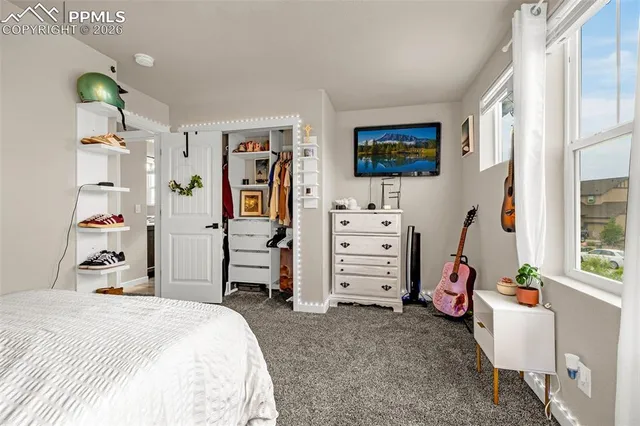 a bedroom with a bed and a desk