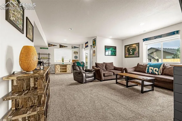 a living room with furniture a rug and a window
