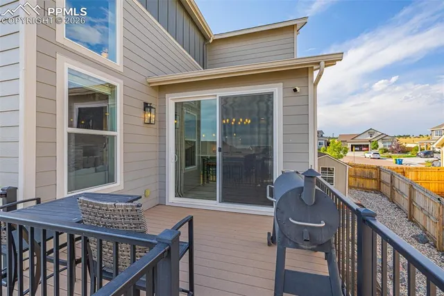 a balcony with table and chairs