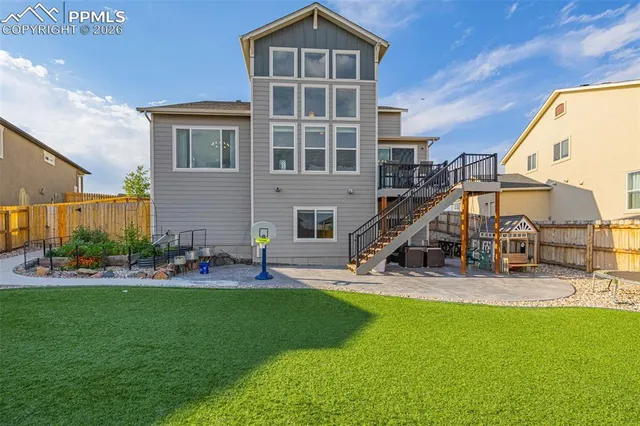 a view of a house with a yard and sitting area