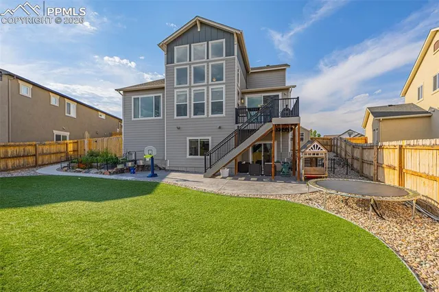 a view of a house with a yard and furniture