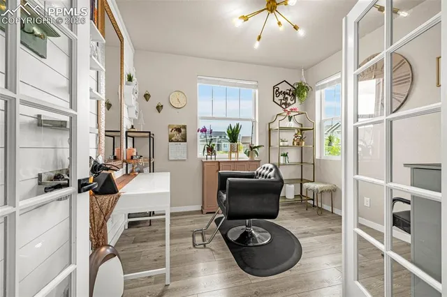 a living room with furniture a flat screen tv and gym equipment