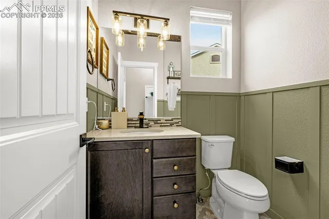 a bathroom with a toilet a sink and a mirror