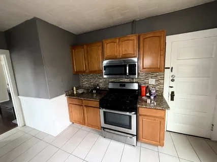 a kitchen with stainless steel appliances a stove a microwave and a refrigerator