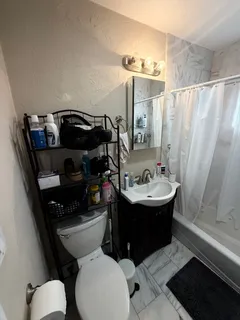a bathroom with a sink toilet and shower