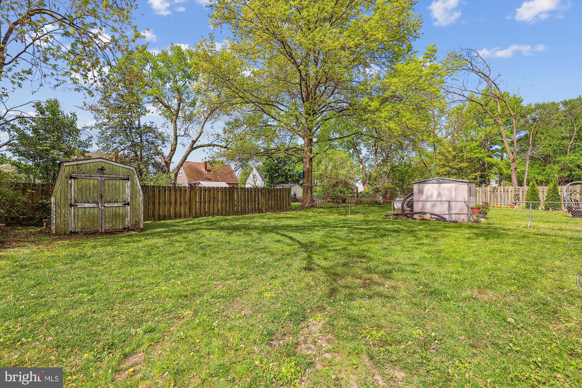 404 Talbott Avenue Laurel, MD 20707 - Photo 17 of 24 a front view of a house with a garden and trees