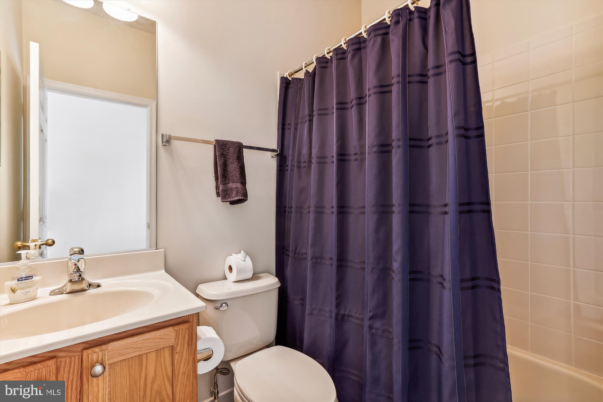404 Talbott Avenue Laurel, MD 20707 - Photo 20 of 24 a bathroom with a sink a toilet and shower curtain