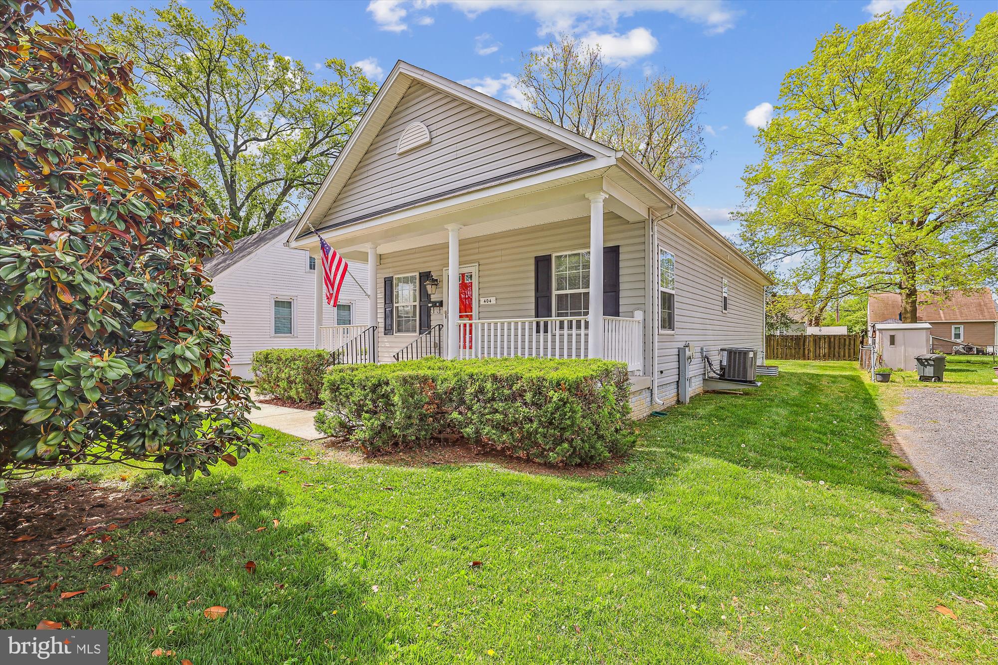 404 Talbott Avenue Laurel, MD 20707 - Photo 3 of 24 a front view of a house with a yard and potted plants