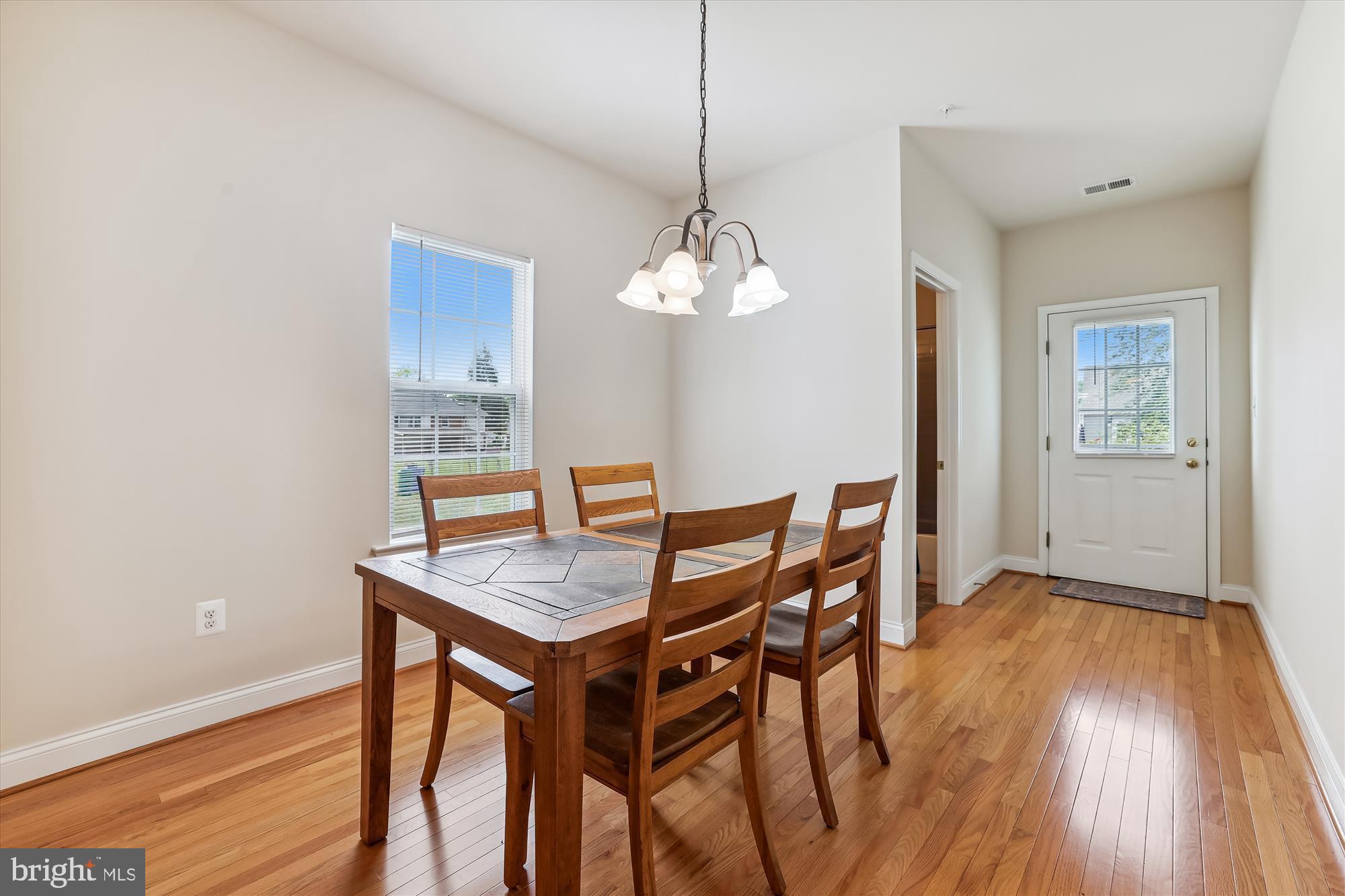 404 Talbott Avenue Laurel, MD 20707 - Photo 5 of 24 a view of a dining room with furniture and wooden floor