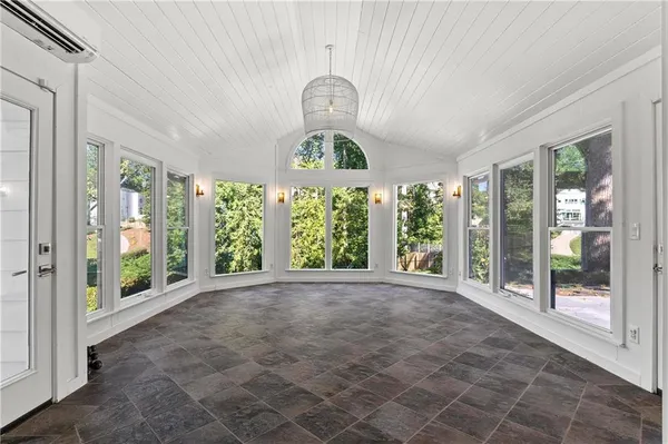 a view of an empty room with windows and entrance