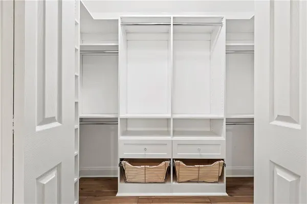 a view of walk in closet with empty racks