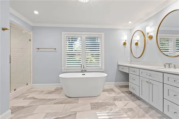 a spacious bathroom with a bathtub sink and mirror