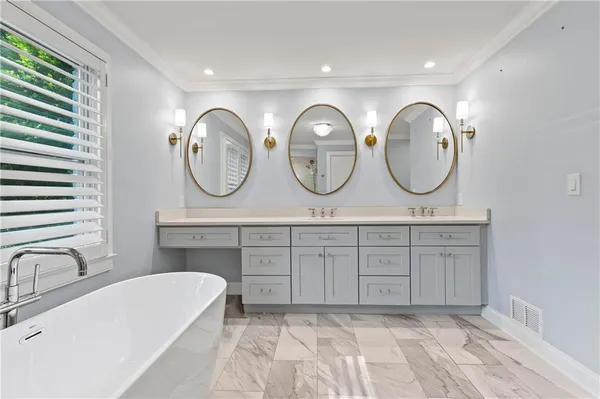 a spacious bathroom with a double vanity sink and a mirror