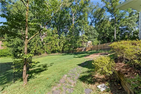 a big yard with lots of green space and trees