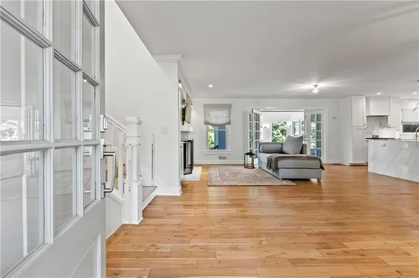 a living room with fireplace furniture and a wooden floor