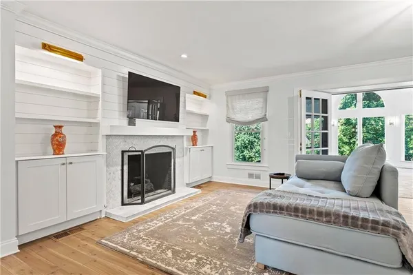 a living room with furniture a window and a fireplace