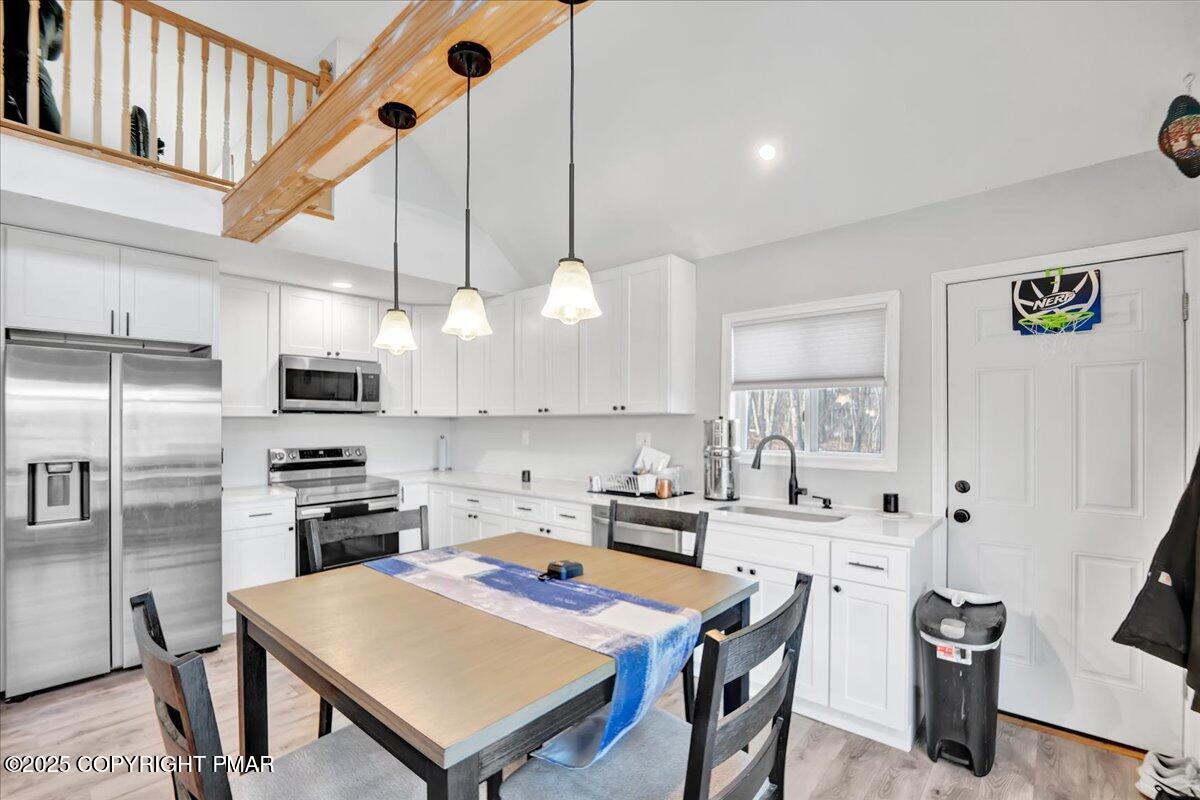 306 Timber Hill Road Henryville, PA 18332 - Photo 3 of 23 a kitchen with stainless steel appliances granite countertop a sink a stove a refrigerator and island with wooden floor