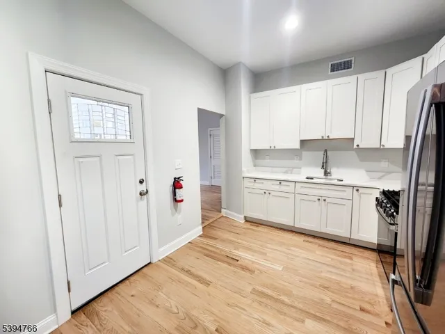 a kitchen with white cabinets and white appliances