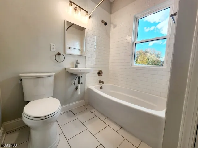 a bathroom with a toilet a sink and bathtub
