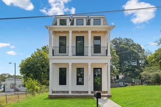 a brick building with a yard in front of it